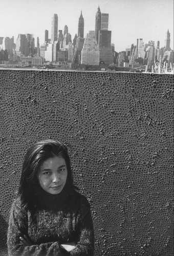 Yayoi Kusama with one of her Infinity Net paintings in New York, c.1961