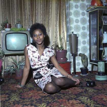 Young Woman Seated on the Floor at Home in front of her Television Set 1973
