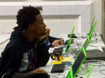 Young coder sitting at a computer